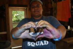 A girl making a heart with her hands.