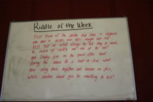 A whiteboard with a riddle written on it.