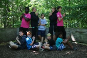 A group of Camp Kupugani campers in the posing in the GaGa Pit.