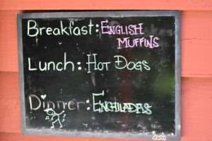 Camp Kupugani chalkboard menu for breakfast, lunch, and dinner.