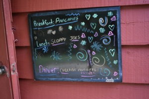A chalkboard with writing and drawings.