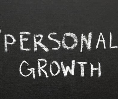 Personal growth written on a chalk board with arrows.