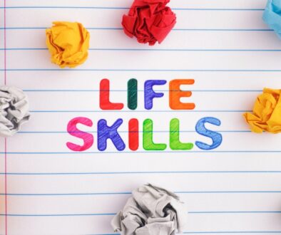 Life Skills in colorful writing in a notebook with colorful balls of paper.