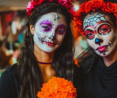 Women wearing traditional calavera (skull) makeup for a Dia de Los Muertos celebration.